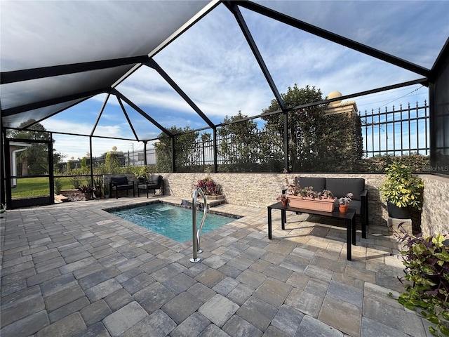 view of swimming pool featuring an outdoor living space, a lanai, and a patio area