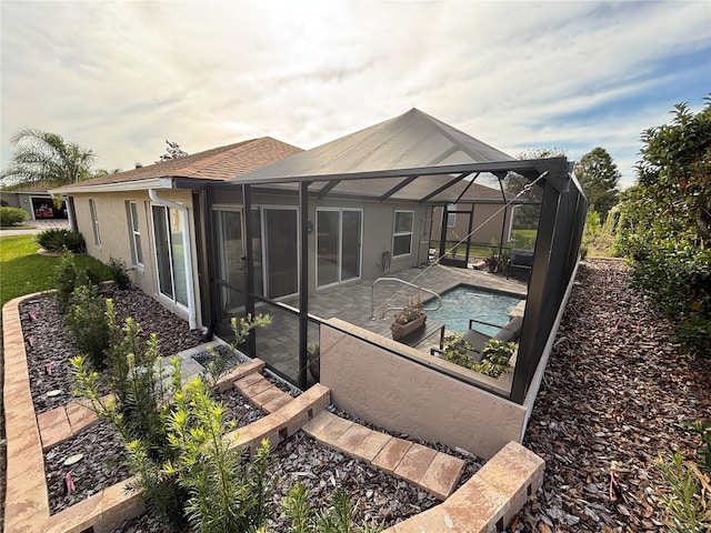 back of property featuring a lanai and a patio