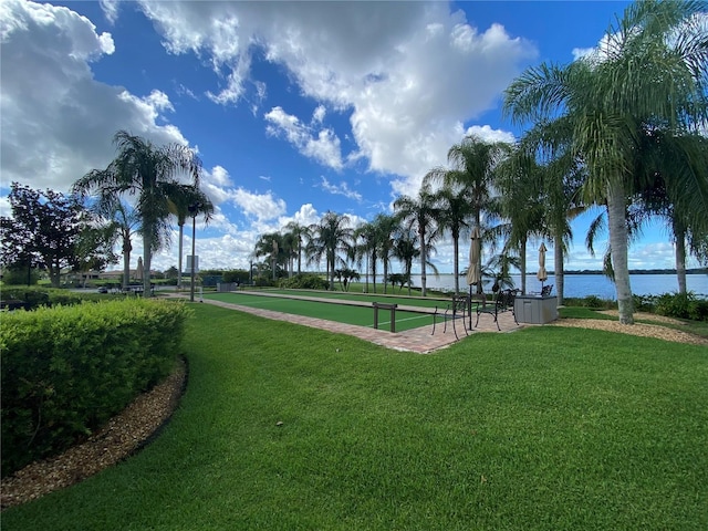 view of community with a water view and a yard