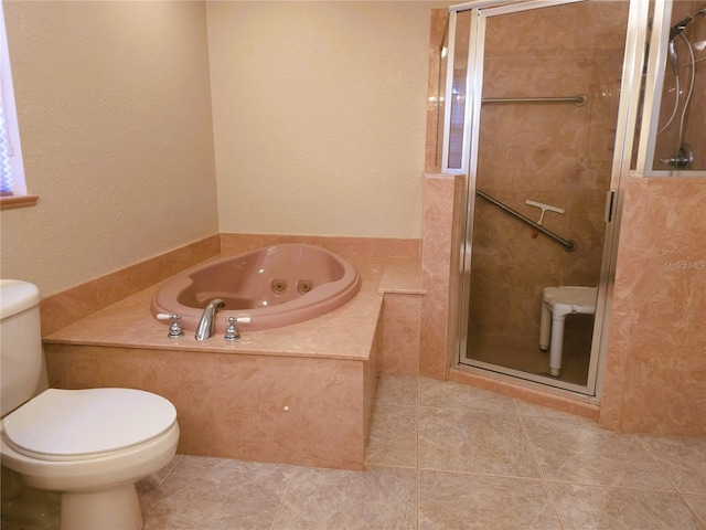 bathroom featuring toilet, tile patterned floors, and shower with separate bathtub