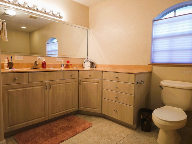 bathroom featuring tile patterned flooring, vanity, and toilet