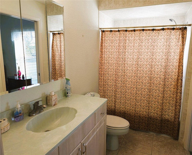 bathroom featuring tile patterned flooring, vanity, curtained shower, and toilet