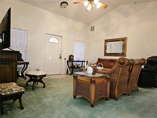 living room with ceiling fan, carpet floors, and high vaulted ceiling