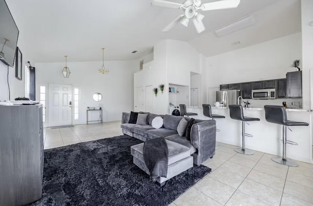 living room with light tile patterned flooring, ceiling fan, and high vaulted ceiling