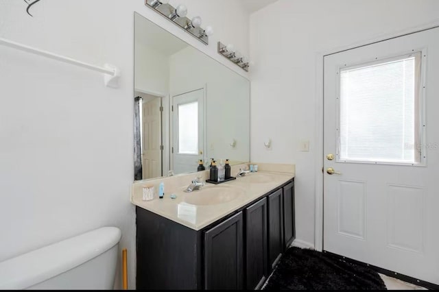 bathroom featuring vanity and toilet