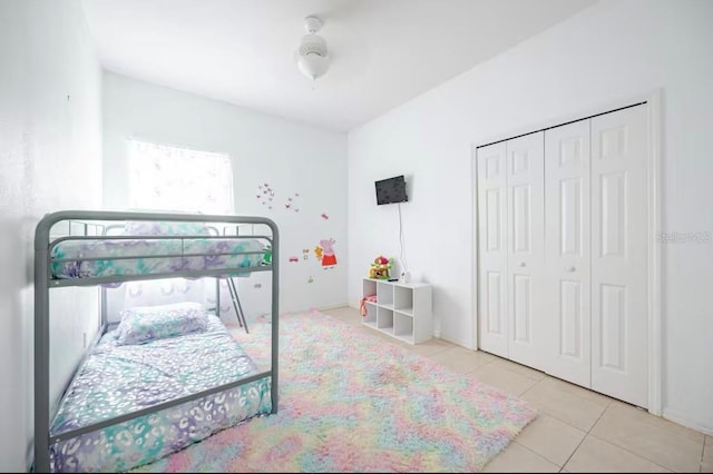 bedroom with light tile patterned flooring and a closet