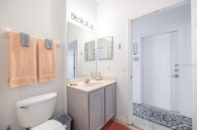 bathroom with vanity, toilet, and tile patterned flooring