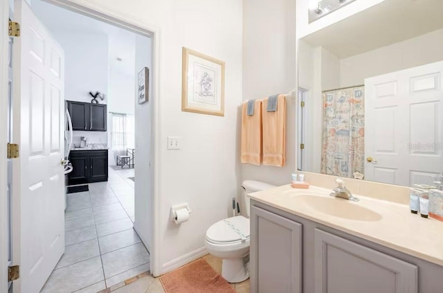 bathroom featuring tile patterned floors, vanity, and toilet