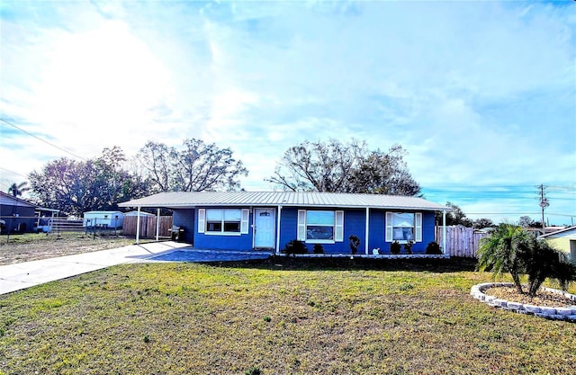 ranch-style house featuring a carport and a front yard