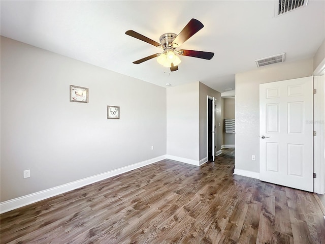 unfurnished bedroom with dark hardwood / wood-style flooring and ceiling fan