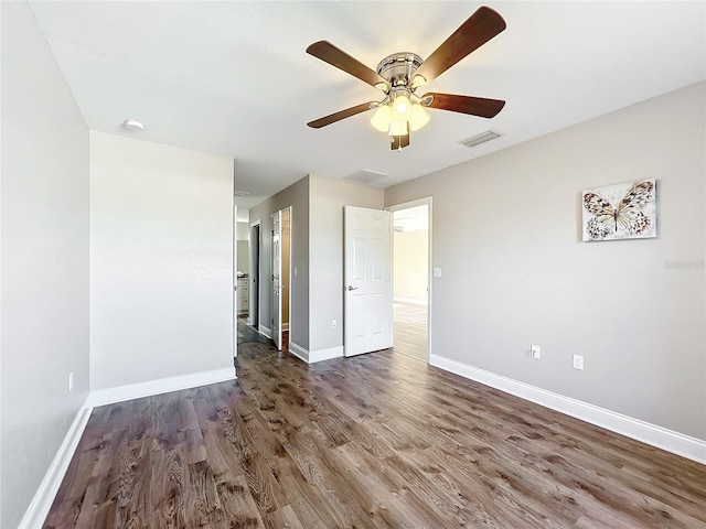 unfurnished room featuring dark hardwood / wood-style flooring and ceiling fan