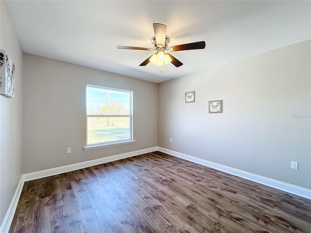 spare room with ceiling fan and dark hardwood / wood-style flooring