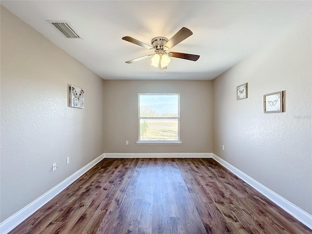 spare room with ceiling fan and dark hardwood / wood-style floors