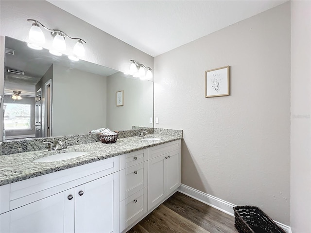 bathroom featuring ceiling fan, vanity, and wood-type flooring