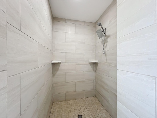 bathroom with a tile shower