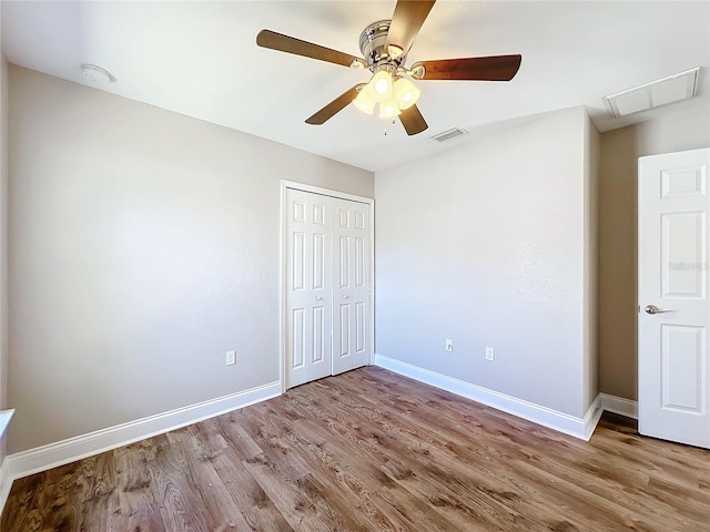 unfurnished bedroom with ceiling fan, light hardwood / wood-style floors, and a closet