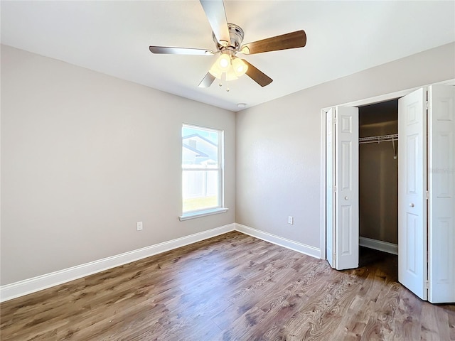 unfurnished bedroom with ceiling fan, light hardwood / wood-style floors, and a closet