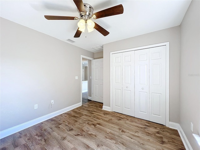 unfurnished bedroom with light hardwood / wood-style flooring, a closet, and ceiling fan