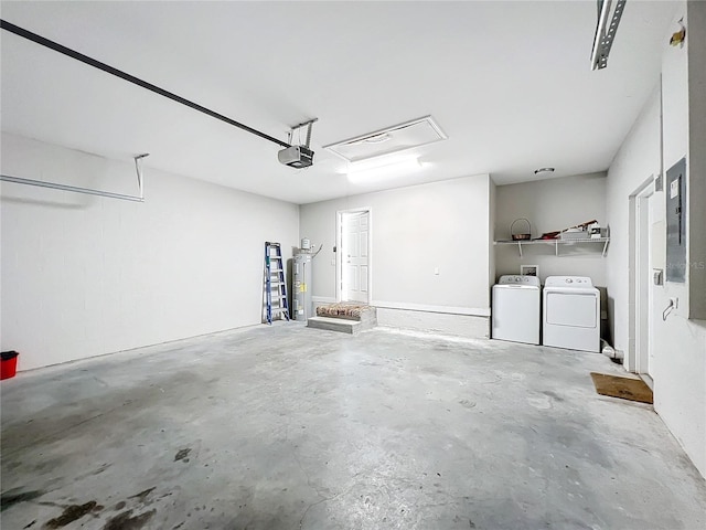 garage with separate washer and dryer, a garage door opener, and electric water heater