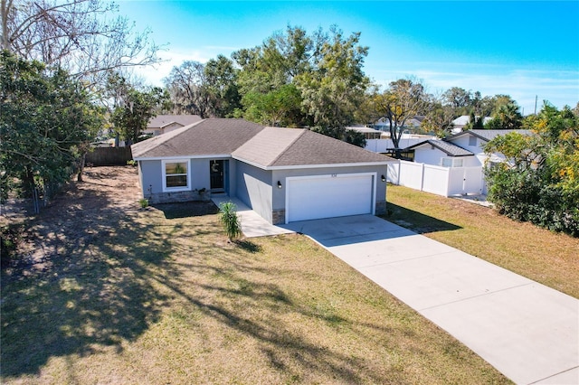 ranch-style house featuring a garage and a front yard