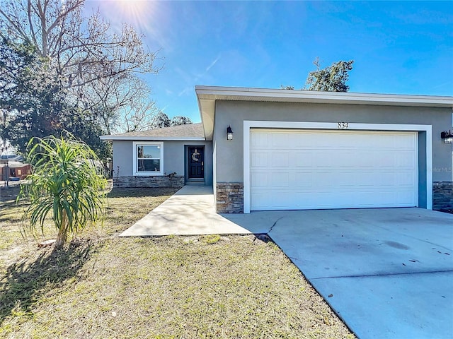 single story home featuring a garage and a front lawn