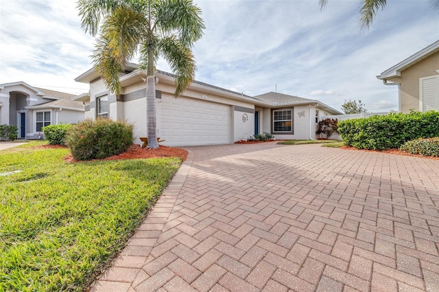 view of front of home with a garage and a front lawn