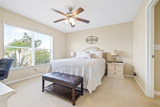 bedroom featuring light carpet and ceiling fan