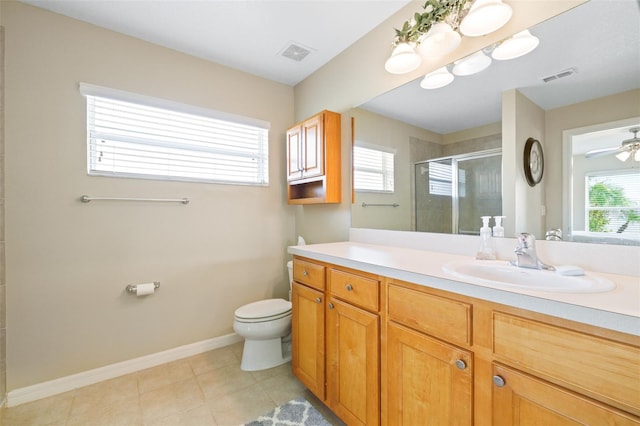 bathroom with a shower with door, ceiling fan, vanity, tile patterned floors, and toilet