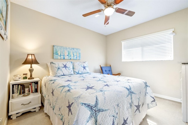 bedroom featuring light colored carpet and ceiling fan