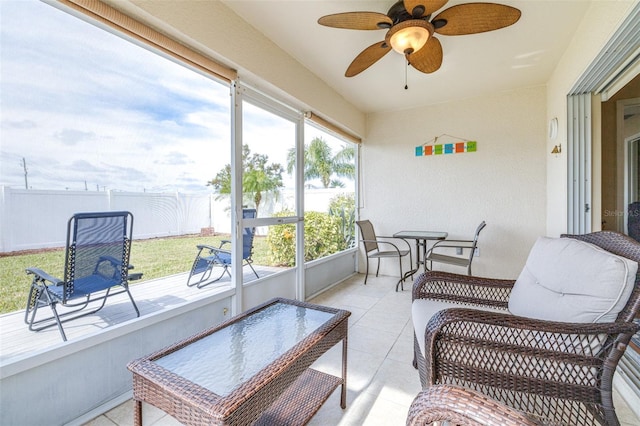 sunroom featuring ceiling fan