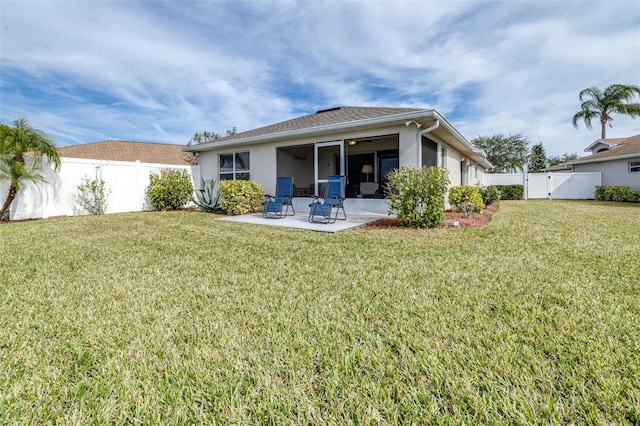 rear view of property with a patio area and a lawn