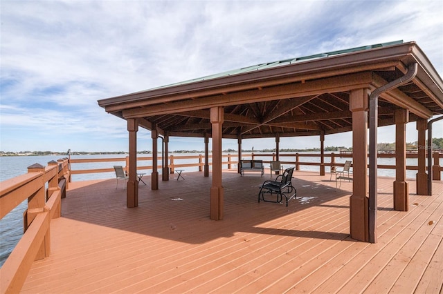 view of dock featuring a gazebo and a water view