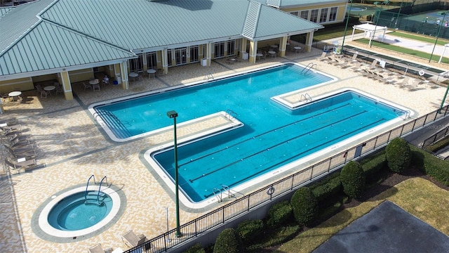 view of pool featuring a hot tub and a patio