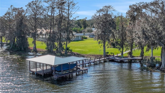 dock area with a lawn and a water view