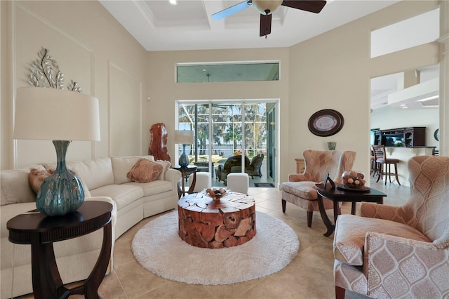 tiled living room with ceiling fan, a towering ceiling, and coffered ceiling