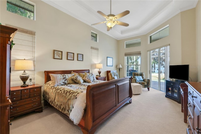 bedroom with crown molding, ceiling fan, access to exterior, light carpet, and a raised ceiling