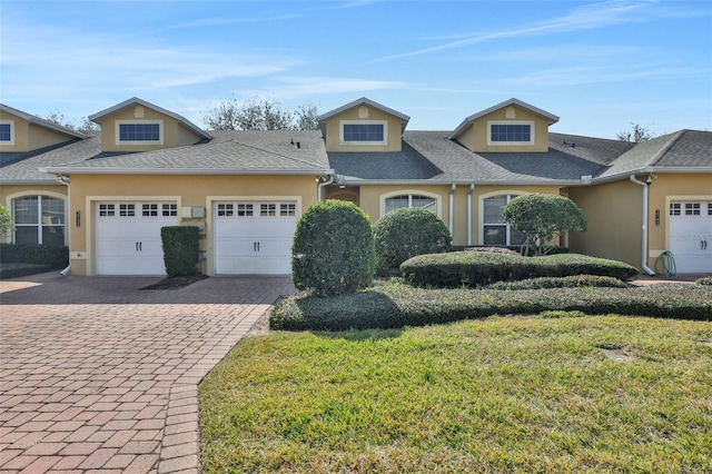 view of front of property featuring a garage and a front lawn