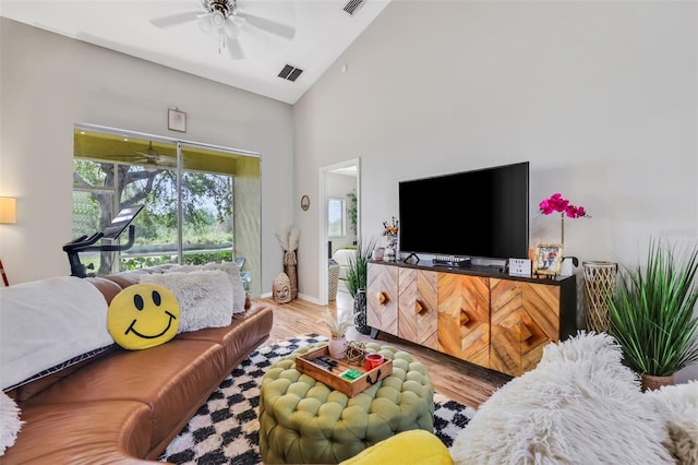 living room with high vaulted ceiling, hardwood / wood-style floors, and ceiling fan