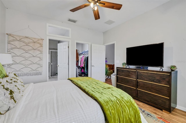 bedroom featuring ensuite bathroom, hardwood / wood-style floors, a spacious closet, ceiling fan, and a closet