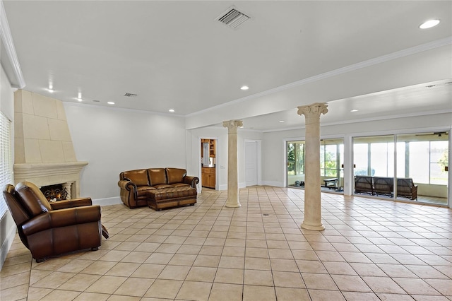 living room featuring ornamental molding, a fireplace, decorative columns, and light tile patterned floors