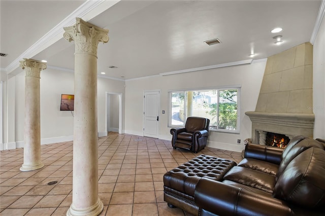 tiled living room with decorative columns, ornamental molding, and a fireplace