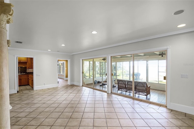 tiled spare room with ornamental molding, a healthy amount of sunlight, and ceiling fan