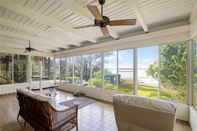 sunroom featuring ceiling fan, wood ceiling, and beamed ceiling