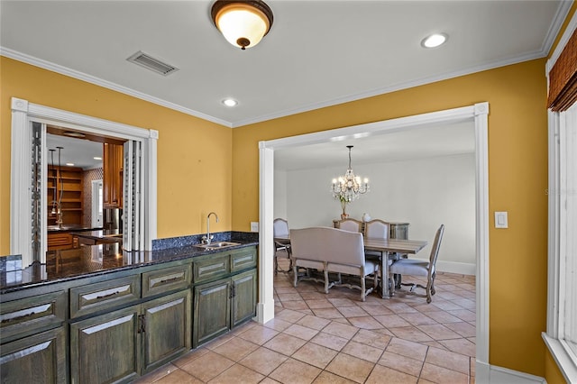 kitchen with pendant lighting, sink, light tile patterned floors, a notable chandelier, and ornamental molding