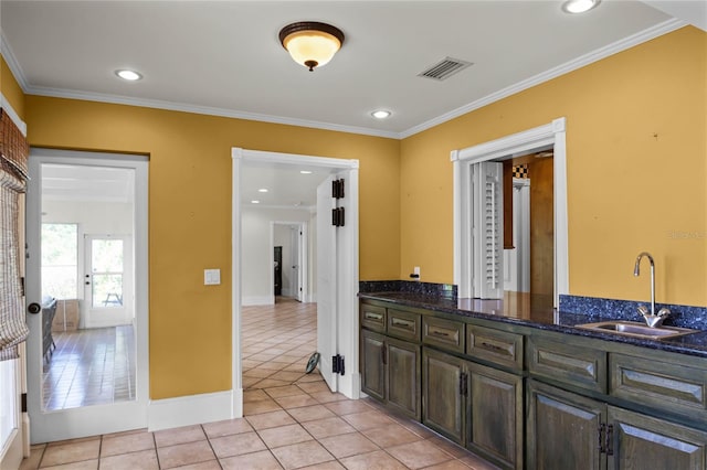 bathroom with tile patterned flooring, vanity, and crown molding