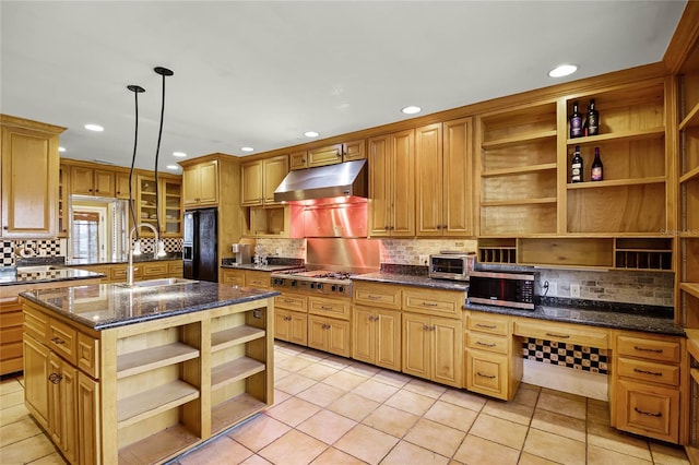 kitchen featuring sink, a center island, built in desk, hanging light fixtures, and appliances with stainless steel finishes