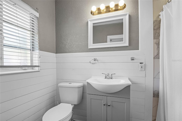 bathroom featuring vanity, toilet, and a shower with shower curtain