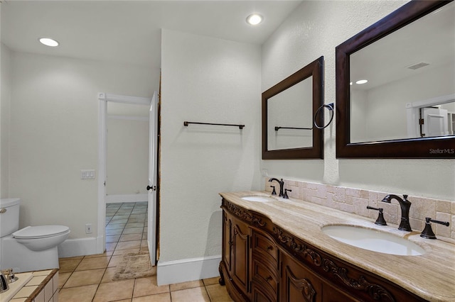 bathroom featuring tile patterned flooring, vanity, and toilet