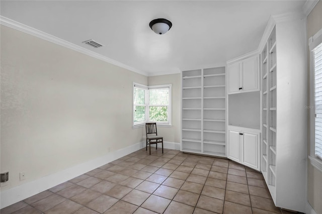 unfurnished room featuring crown molding, light tile patterned flooring, and built in shelves