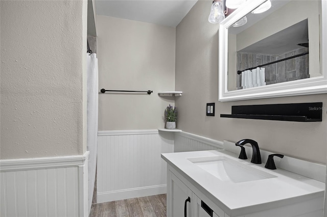 bathroom featuring vanity, hardwood / wood-style floors, and walk in shower